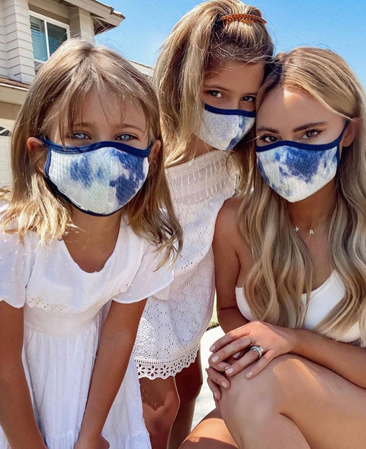 3 Atlantic face masks with adjustable straps worn by women and children